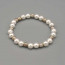Braccialetto elastico con perle bianche e argento